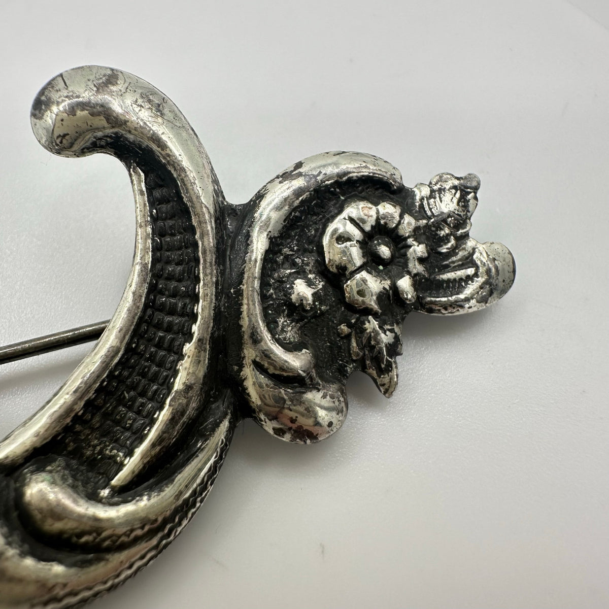 Vintage silver tone Art Nouveau Revival embossed scrollwork floral brooch