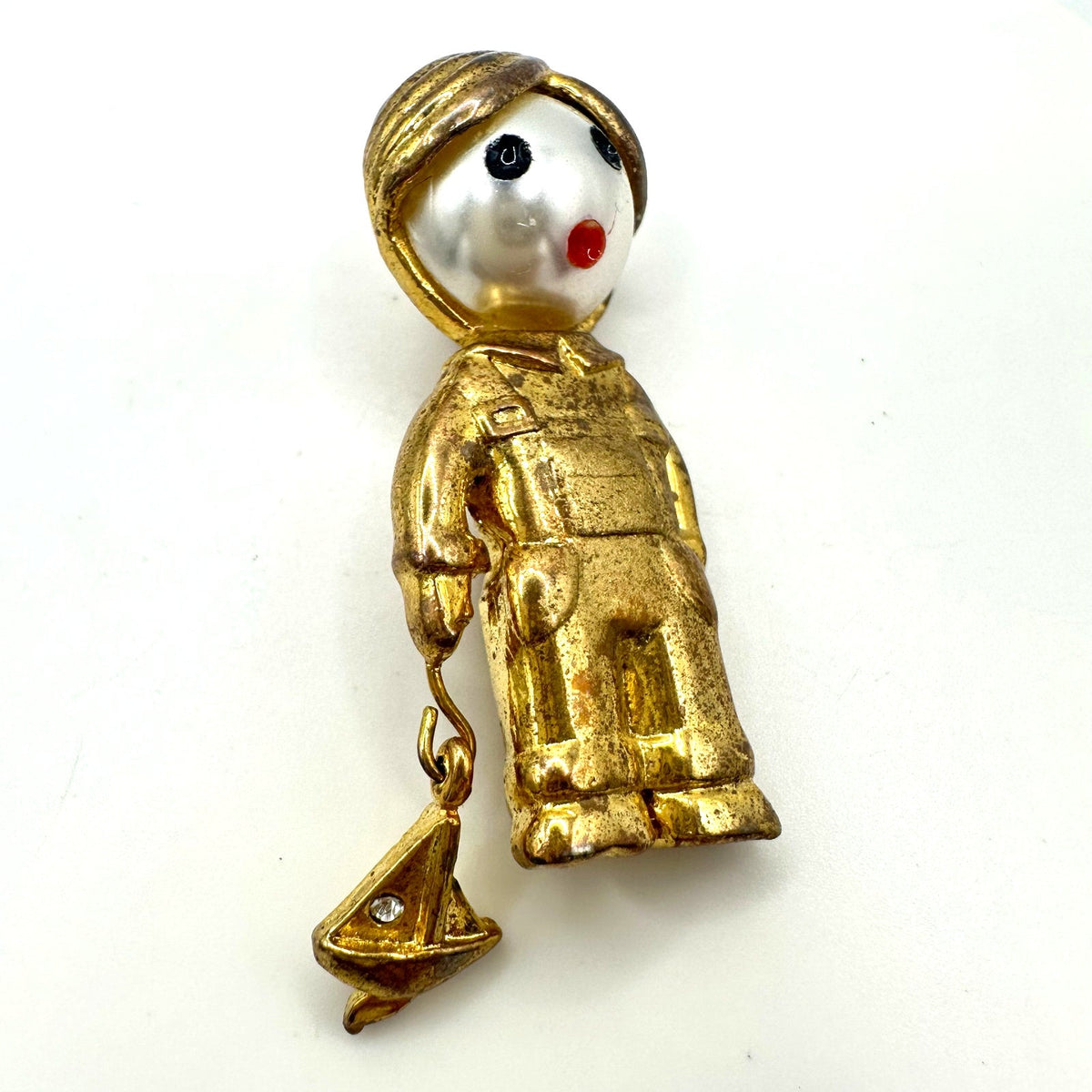 Vintage gold tone boy child with sailboat faux pearl articulated figural brooch
