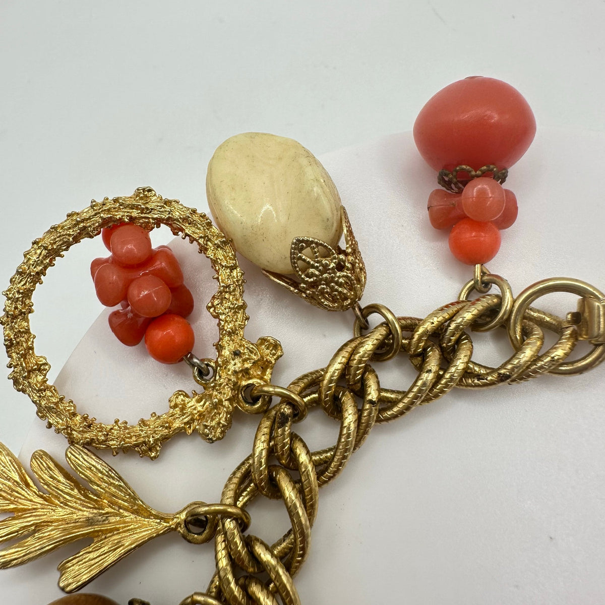 Vintage Victorian Revival gold tone faux coral lucite glass charms bracelet
