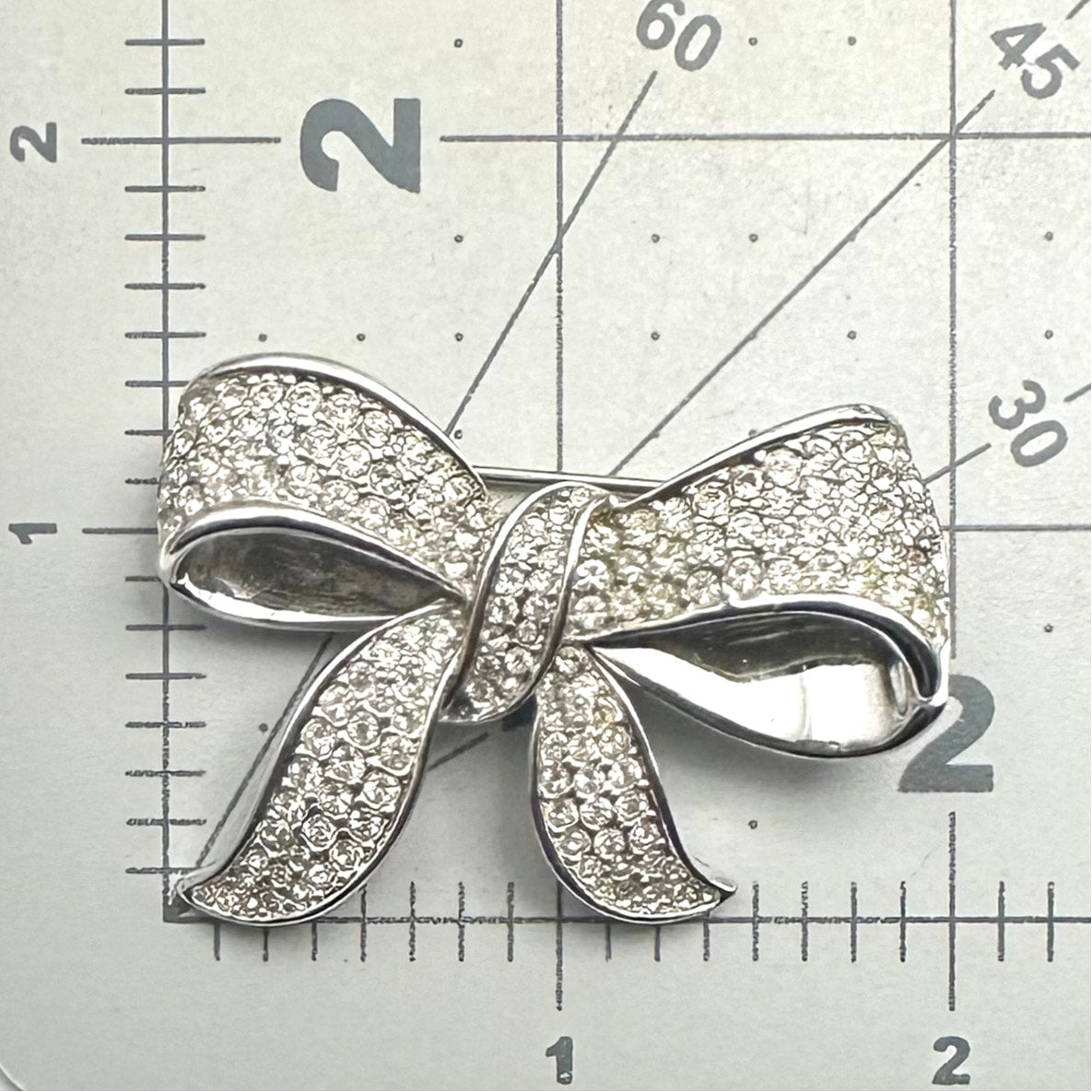 Oscar De La Renta vintage silver tone rhodium plate clear rhinestones bow brooch
