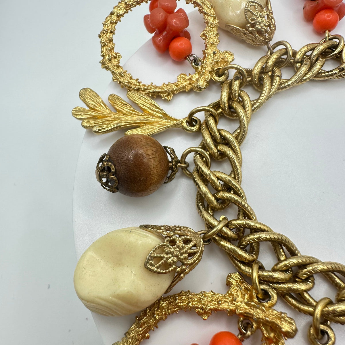 Vintage Victorian Revival gold tone faux coral lucite glass charms bracelet