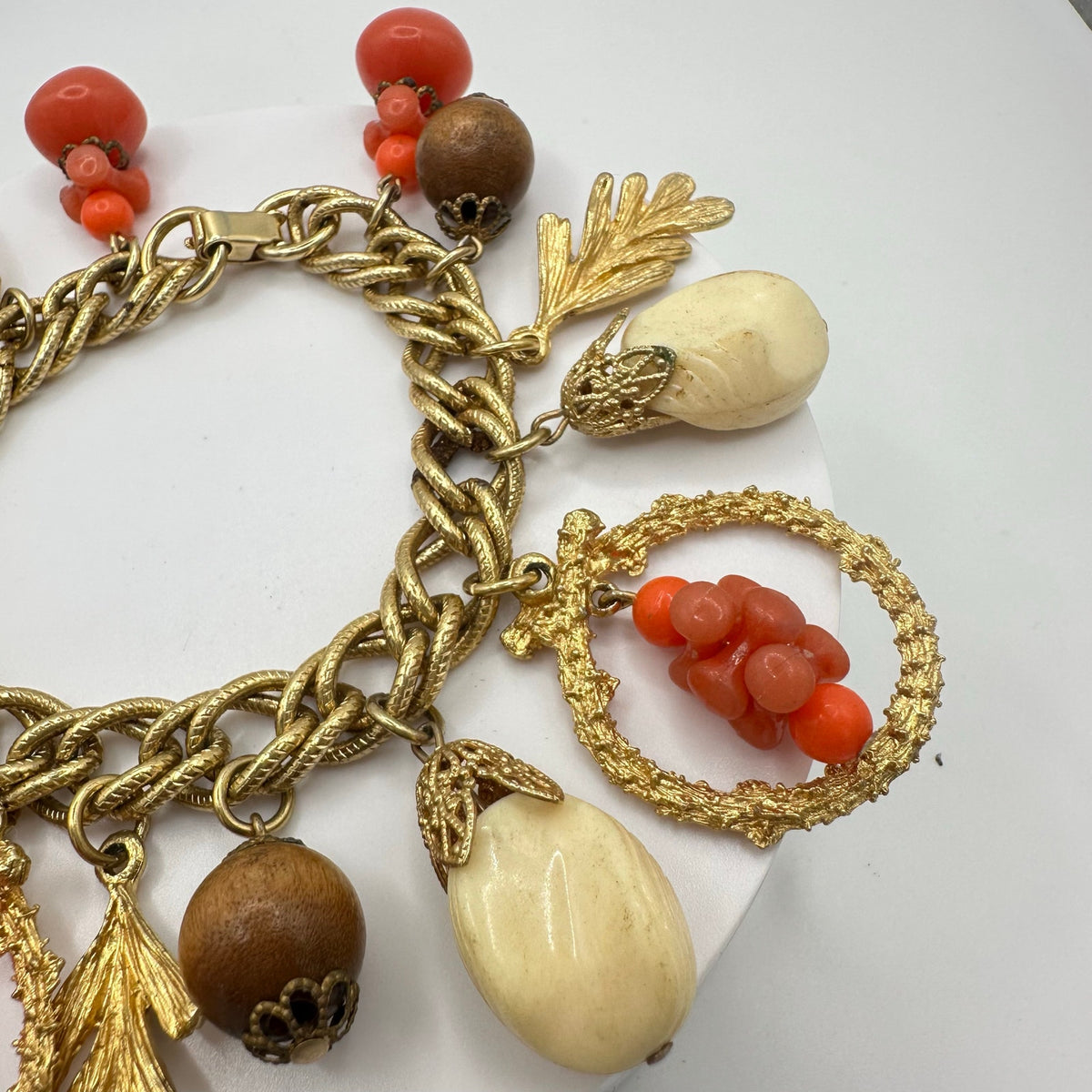 Vintage Victorian Revival gold tone faux coral lucite glass charms bracelet