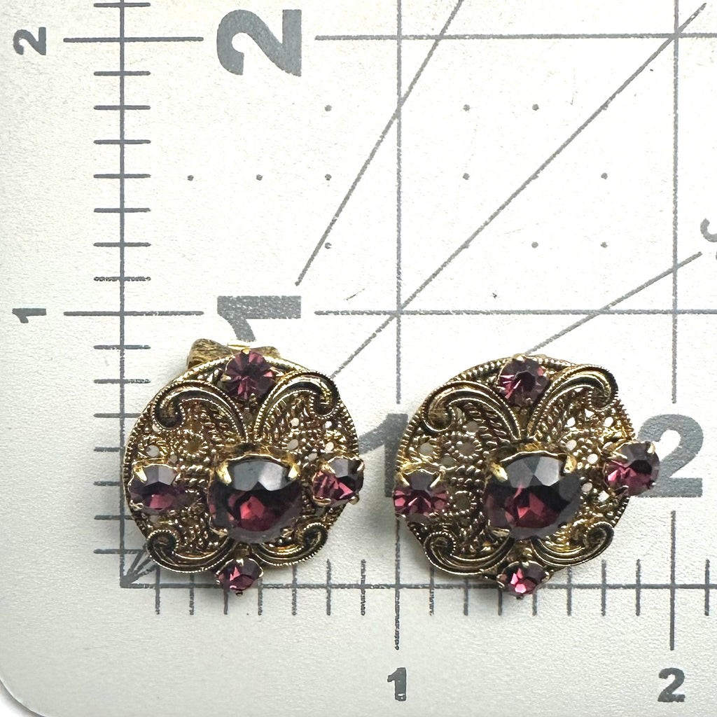 Vintage 1950s gold tone filigree purple glass rhinestones clip on earrings