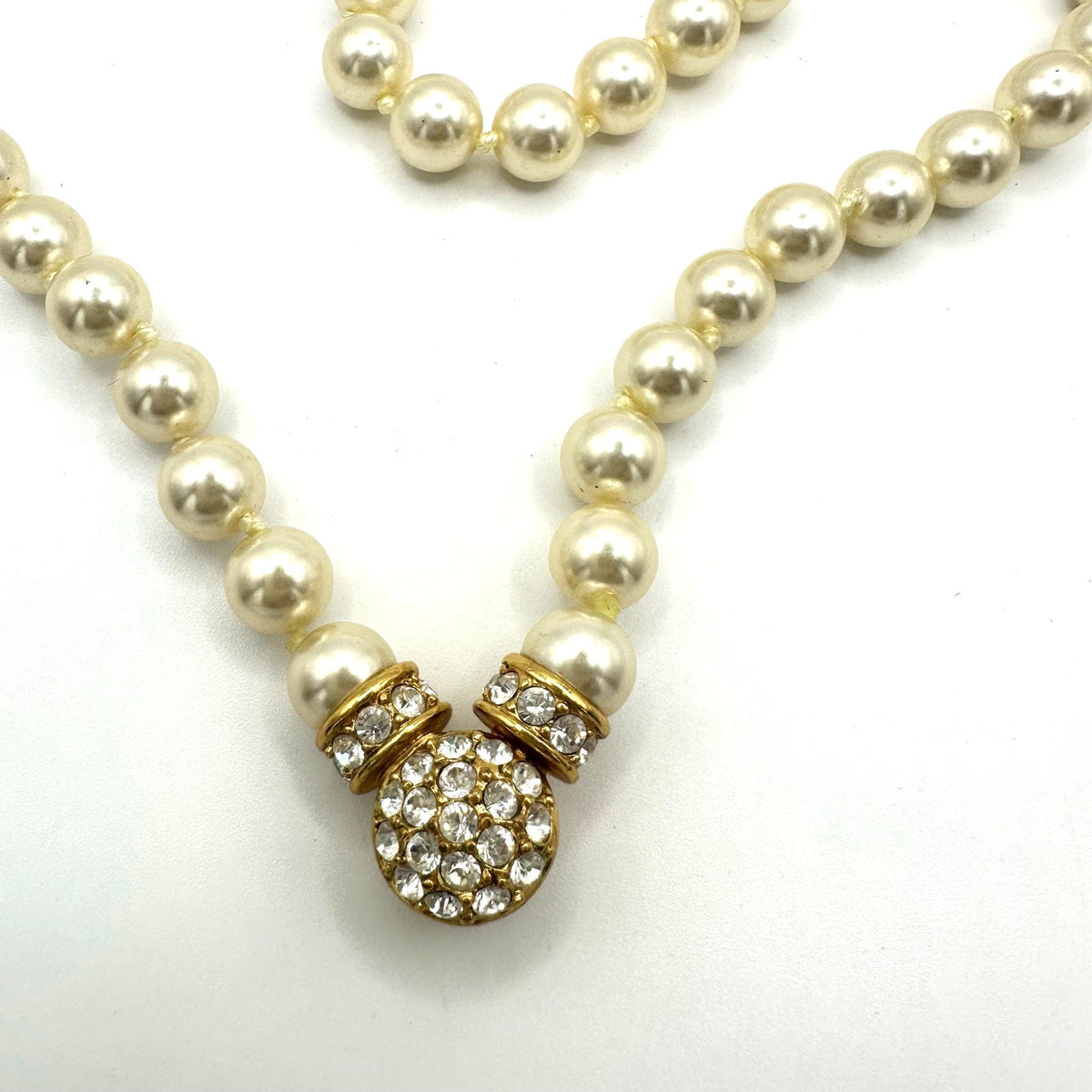 Nolan Miller gold tone white 8mm glass faux pearls rhinestones knotted necklace