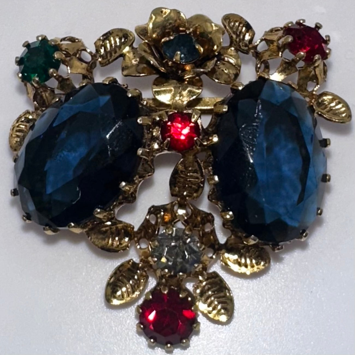 Unsigned Austria 1950s vintage gold tone multicolor rhinestones floral brooch