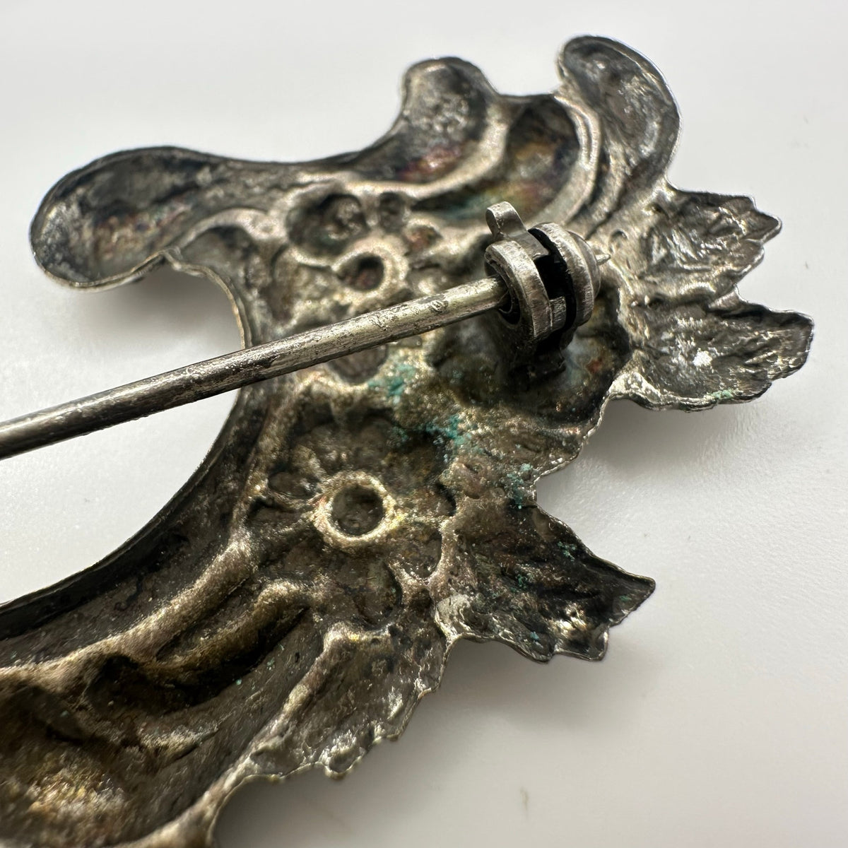 Vintage silver tone Art Nouveau Revival embossed scrollwork floral brooch