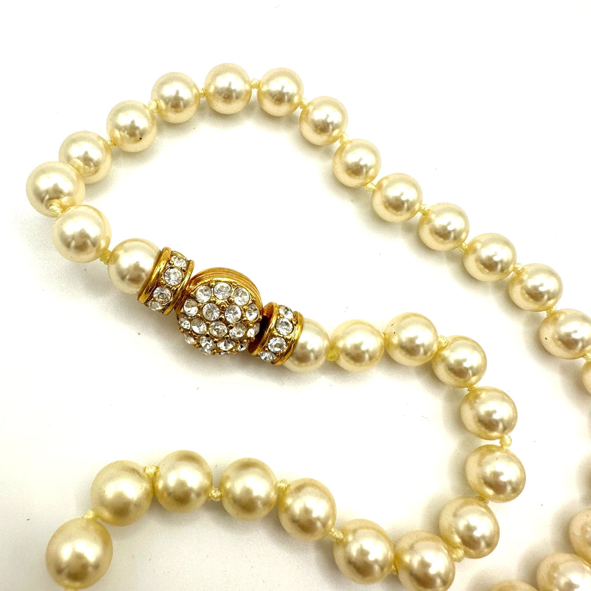 Nolan Miller gold tone white 8mm glass faux pearls rhinestones knotted necklace