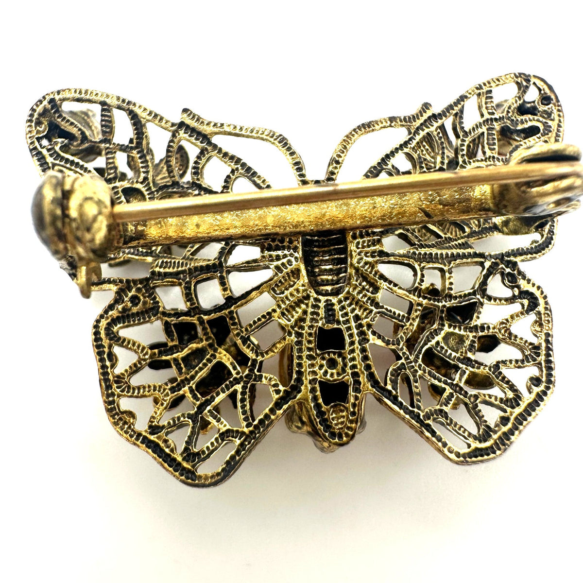 Vintage gold tone filigree multicolor prong set rhinestones butterfly brooch