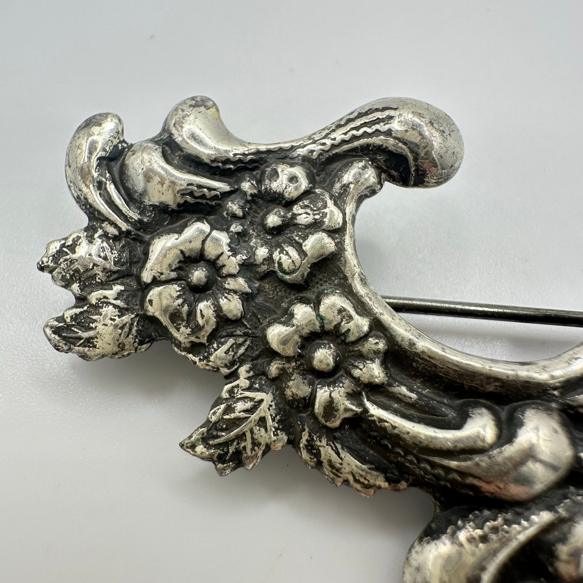 Vintage silver tone Art Nouveau Revival embossed scrollwork floral brooch