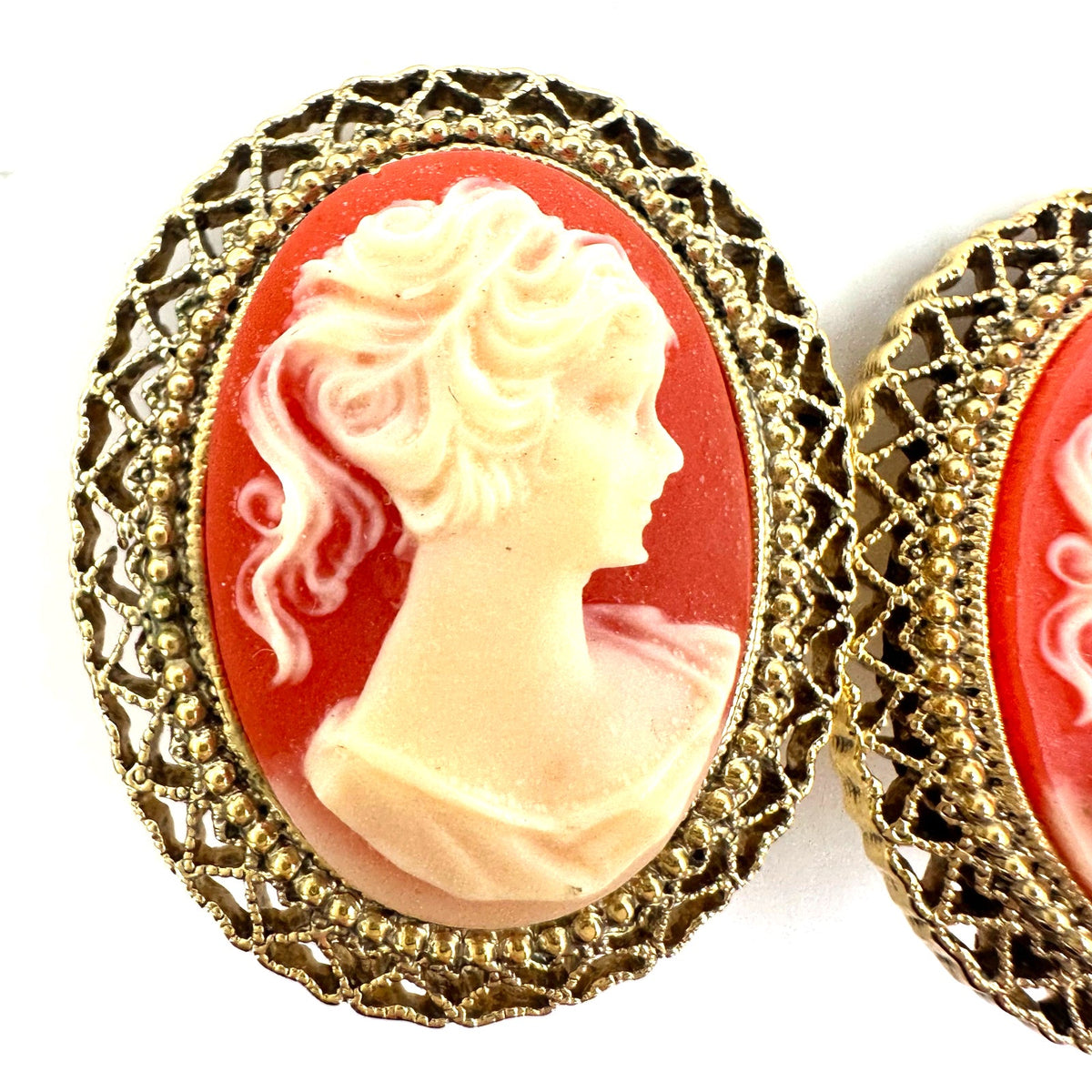 1928 signed gold tone pink resin cameo woman's face oval clip on earrings
