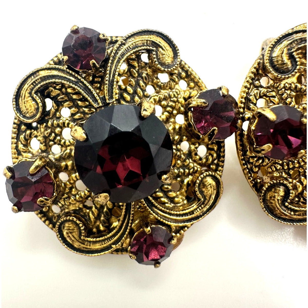 Vintage 1950s gold tone filigree purple glass rhinestones clip on earrings
