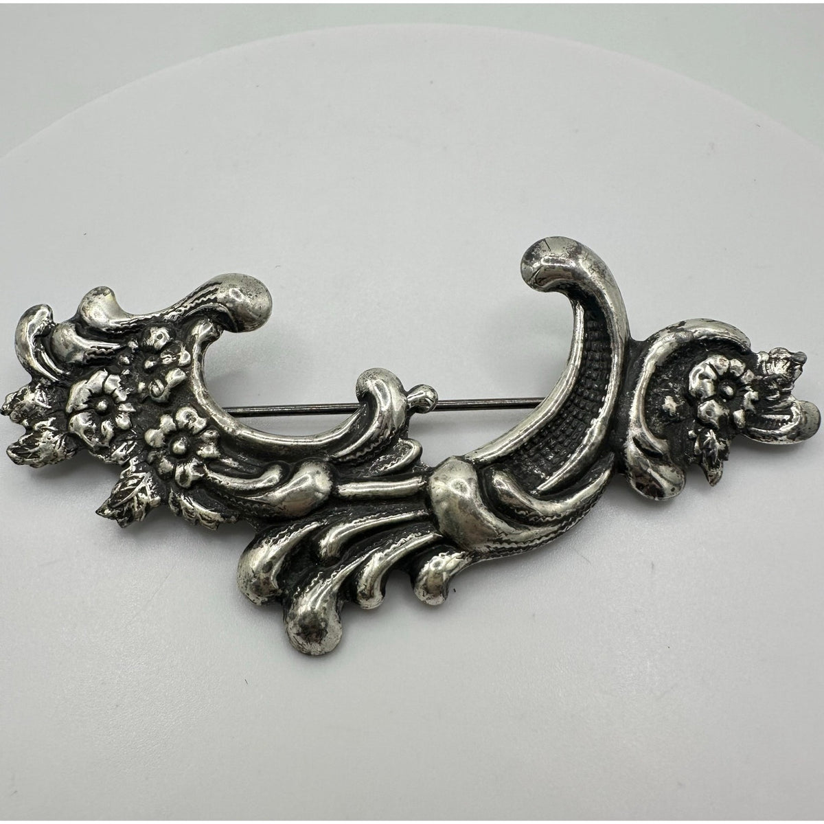 Vintage silver tone Art Nouveau Revival embossed scrollwork floral brooch