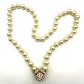 Nolan Miller gold tone white 8mm glass faux pearls rhinestones knotted necklace
