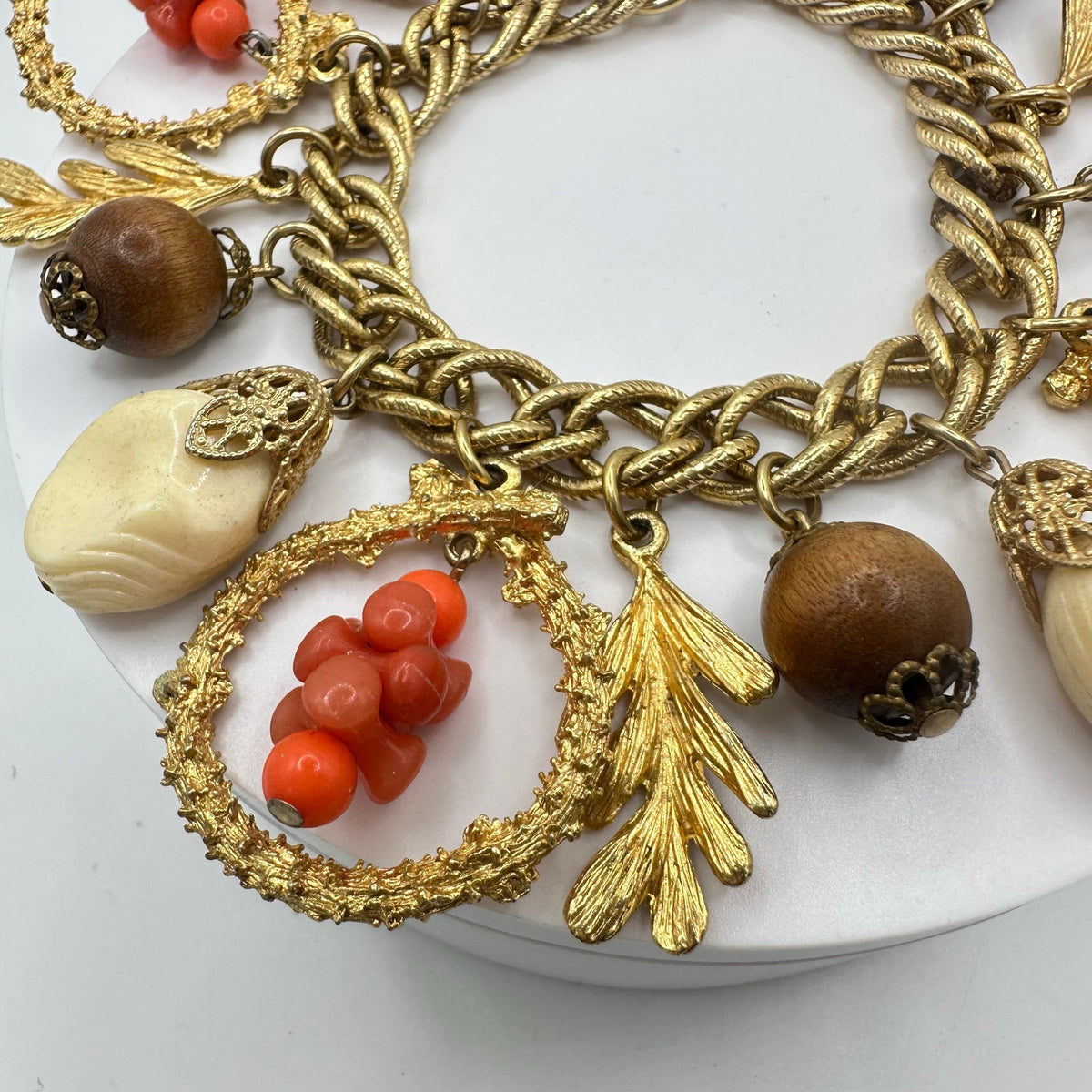 Vintage Victorian Revival gold tone faux coral lucite glass charms bracelet
