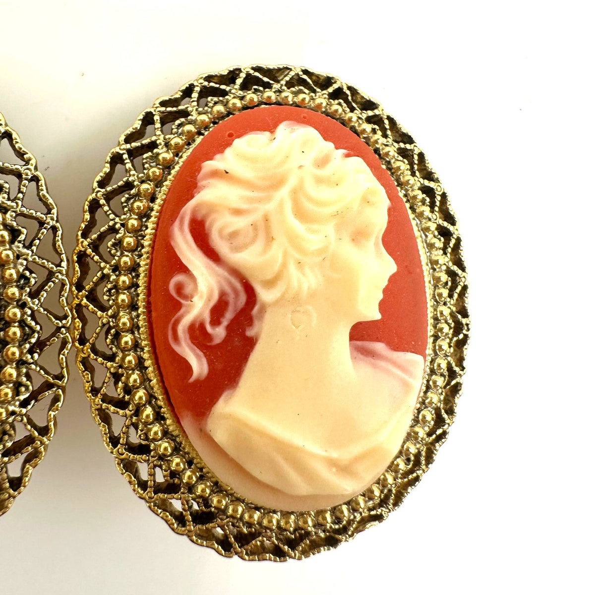 1928 signed gold tone pink resin cameo woman's face oval clip on earrings